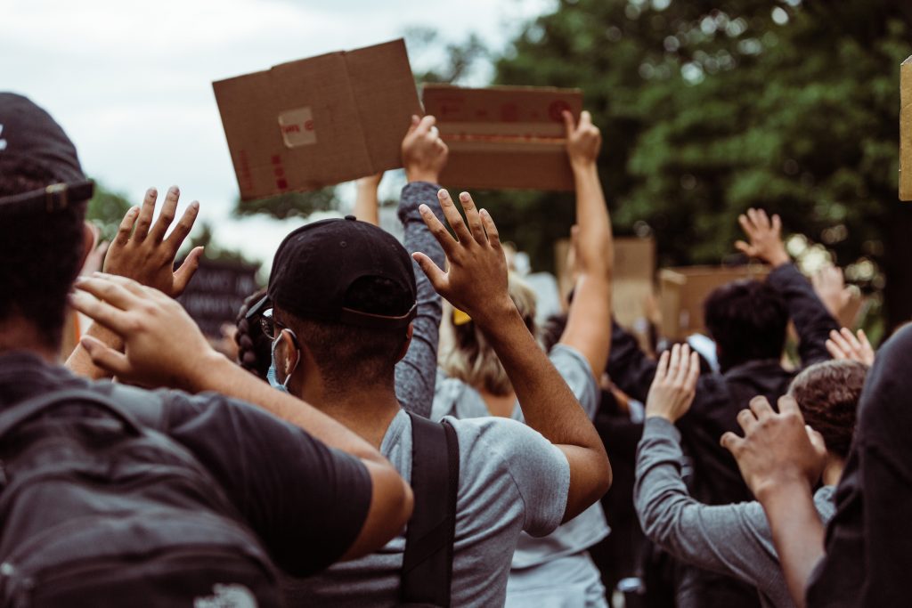 Protesters gathered with hands in the air