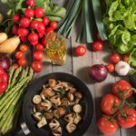 Fresh vegetables and fried mushrooms in a pan