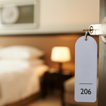 Open door of a hotel room with key in lock