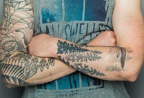 Crossed tattooed arms
