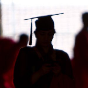 Silhouette of graduating students in cap and gown