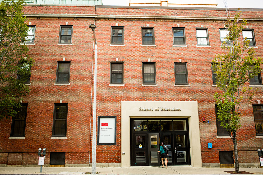 A student walks into the Boston University School of Education building