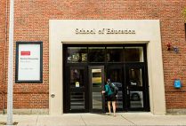 A student walks into the Boston University School of Education building