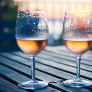 Two glasses of chilled rose wine on a picnic table