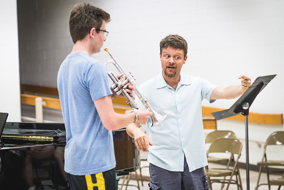 Ben Wright gives trumpet player Jon-Michael Taylor advice