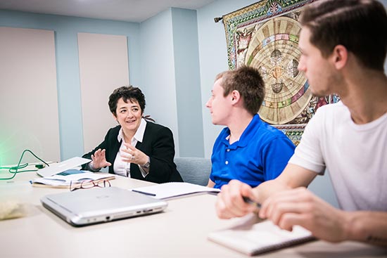 Associate Professor of Astronomy and Director of the Boston University REU program Merav Opher talks with REU students