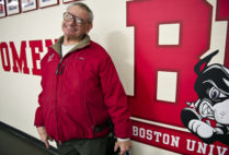 Elliot Driben grinning in front of BU Terrier mural