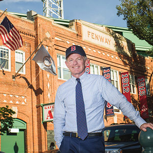 Professor Tom Whalen poses for a photo in front of Fenway Park