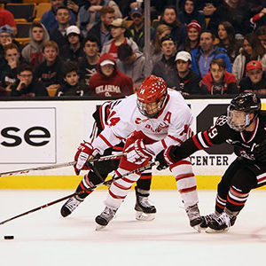 BU Terriers men's hockey player Bobo Carpenter fights for the puck during the 2018 Beanpot Tournament men's hockey championship game