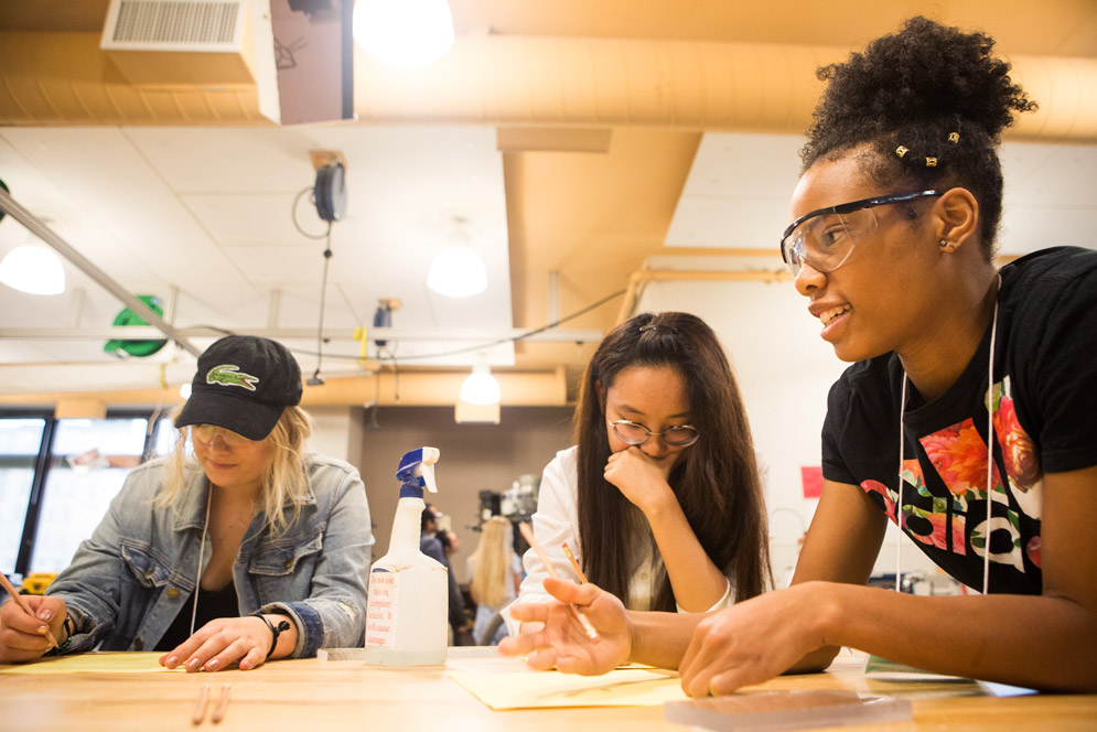 Team One's Sophia Crandall (Questrom’19) (from left), Moyan Xu (Questrom’20), and Leah Fowlkes (Questrom’20) sketch up a plan for their tower.