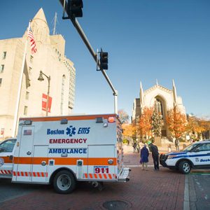 A BU police vehicle is parked in front of Marsh Chapel on a beautiful fall day.