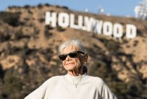 Jo Farkas poses for a photograph in front of the iconic Hollywood sign