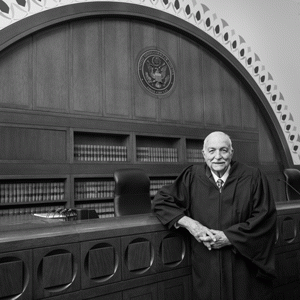 Judge Juan Torruella posing in the courtroom