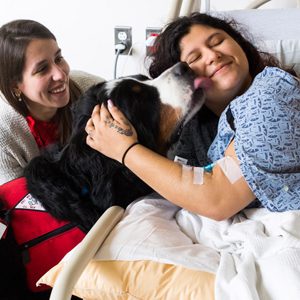 Cara Guenther and Otis visit Darinta Larios in BMC's Pediatric Inpatient Unit