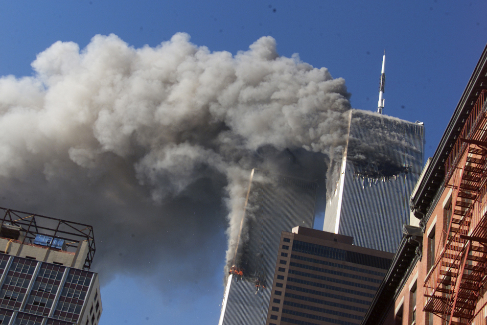 the twin towers smoking as seen from the street a few blocks away