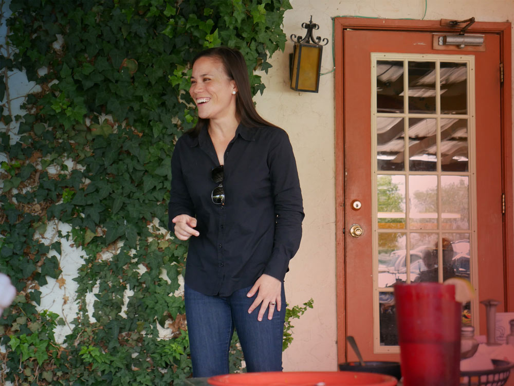 2018 midterms candidate from Texas, Gina Ortiz Jones, poses for a photo smiling/laughing.