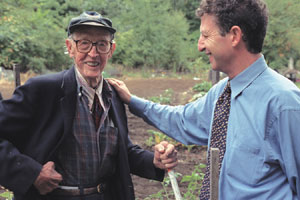 Thomas Perls, a MED professor and director of BU’s New England Centenarian Study (right), the world’s largest genetic study of people over the age of 100, talks with Nelson McNutt at his home in Weston, Mass. McNutt was born June 11, 1899. Photo by Fred Sway