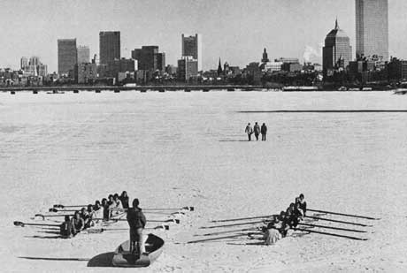 Photograph of students rowing on a frozen Charles River.