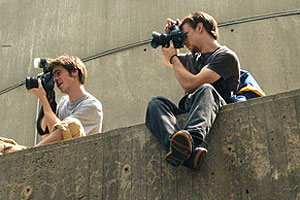 Galen Mook (CAS’06) and T. J. Kirkpatrick (CAS’06) photograph an anarchist protest from above Boylston Street on July 29. Photo by Adrienne Carp (COM’04)