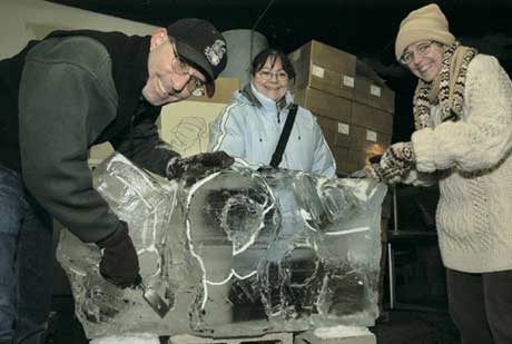 The Office of Disability Services won the annual ice sculpting contest at the Universitys holiday party for a frozen work that depicts three hands spelling the word joy in sign language. On December 16, Dann Berkowitz, the offices assistant director, Michelle Reynolds, an administrative coordinator, and Wanda Velez-Jusino, a senior staff assistant, begin to carve their 300-pound block of ice. Photo by Albert LEtoile
