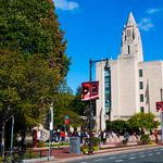 Large group of students walking on sidewalks on Boston University's campus