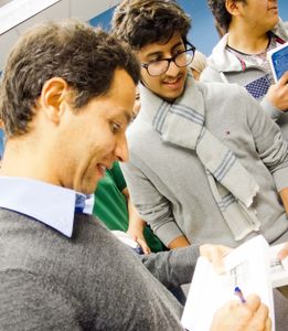 Qais Akbar Omar signs books and engages students in conversation.