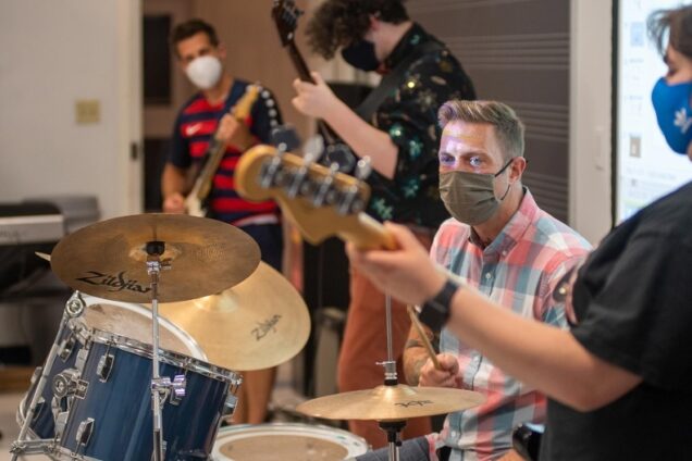 Music teacher Paul Halpainy (CFA’12,’24) takes over on drums during a jam session with classmates in CFA’s Rock Band Performance & Pedagogy class.