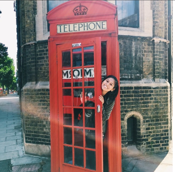 Jennifer Gonzales takes a photo in one of London's iconic red telephone boxes