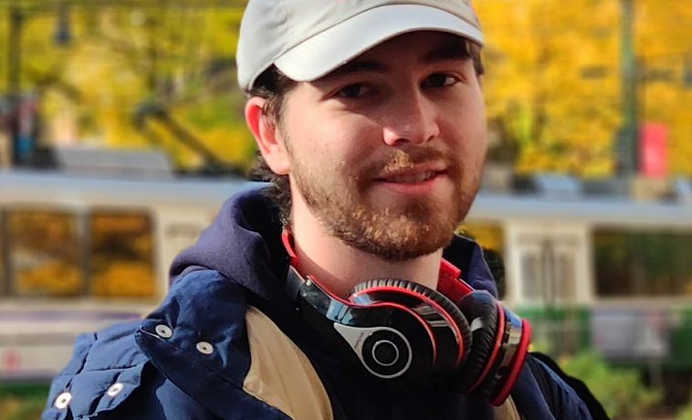 Eric Hansen wearing a baseball cap and smiling.