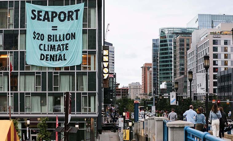A banner dropped by members of climate activist movement Extinction Rebellion in Boston’s Seaport warning of the threat to the district of sea level rise.