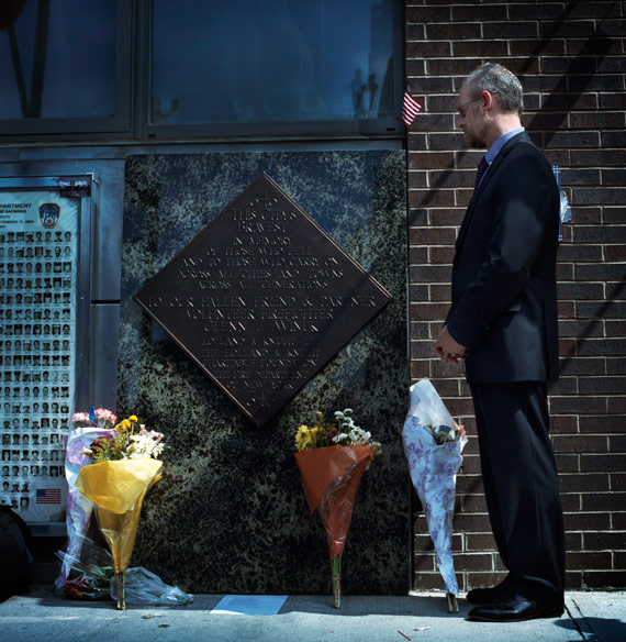 11-3913-WINUK-003 At the fire station across the street from Ground Zero, Jay Winuk (’82) visits the plaque honoring his brother, a first responder on 9/11. Photo by Béatrice de Géa.