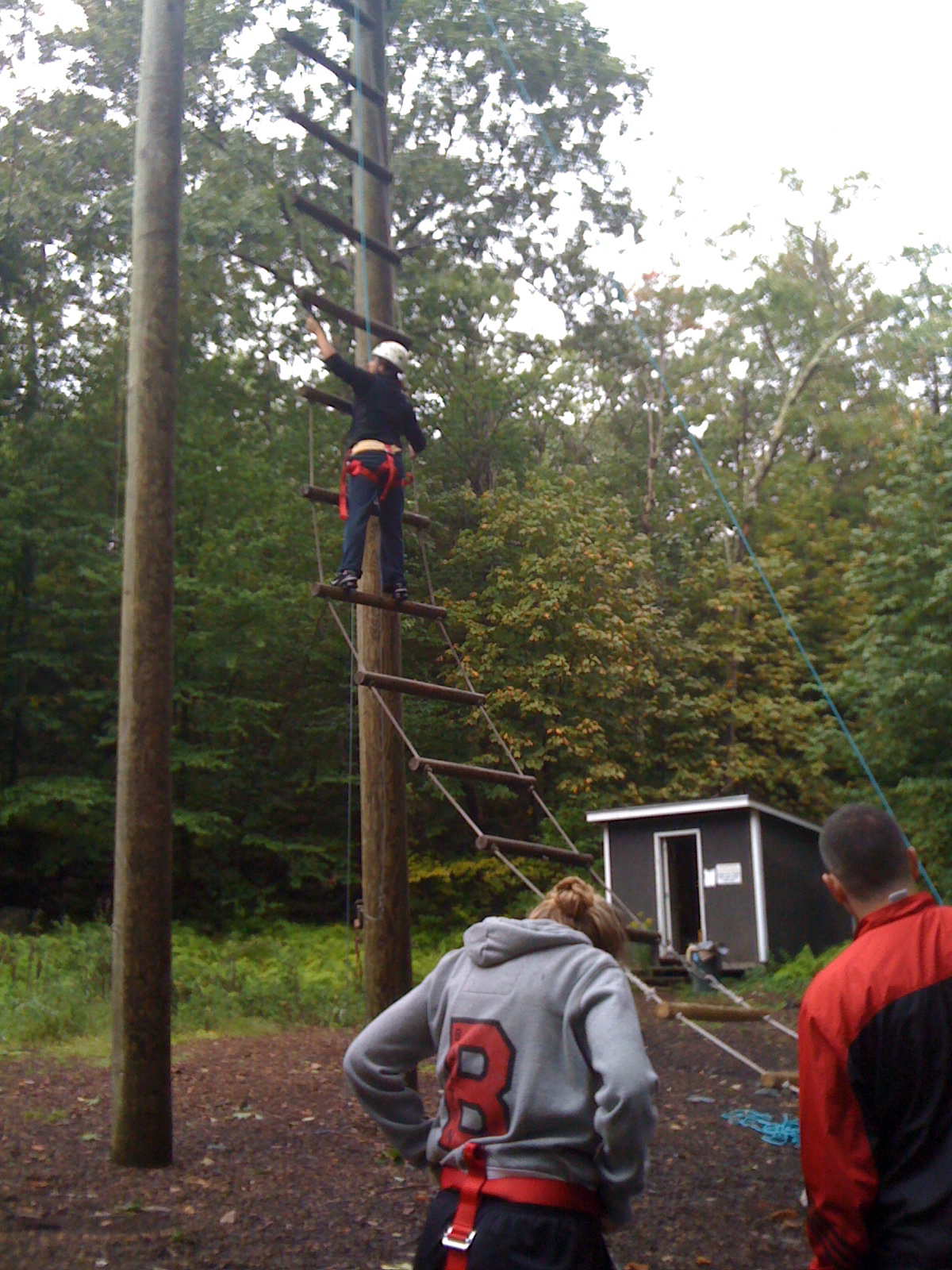 Missy climbing up the ladder to the ropes course