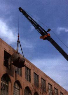 Vacuum tank being lifted by crane into the CAS building