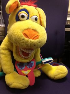 Dooggie the Dog is a puppet used to teach children proper bushing techniques