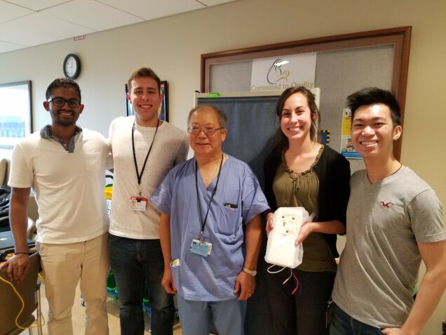Mohit Dangeti (BME '17, '19), Charles Scheftic III (BME), Dr. Alan Fujii, Elizabeth Sridhar (BME), Nicholas Leung (BME '17) gather at Boston Medical Center to show off the neonatal vitals monitoring pad prototype.
