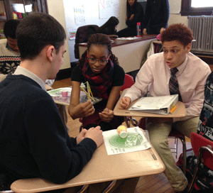 Inspiration Ambassador Aniekan Inoyo (ME15, center) works with Dorchester MA high school students engineering a cellphone wireless business.