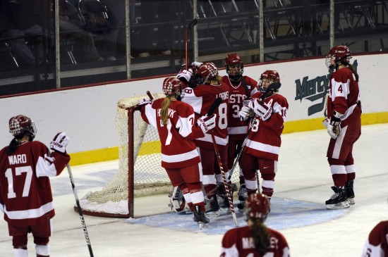 Boston University Women's Ice Hockey team gathers at their net after they lose 4-1 to Wisconsin in the final championship game of the 2011 Frozen Four.
