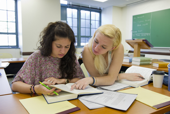 Olivia Oberndorf (CAS,'13), left, and Karissa Hurzeler (CAS'13) translating a section of the Rosetta Stone during the Middle Egyptian summer course. Photo by Cydney Scott for Boston University Photography.