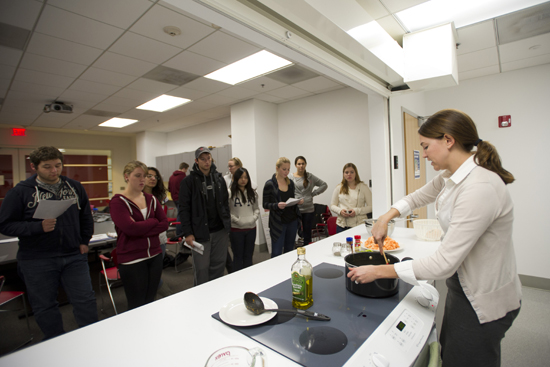 Laura Judd demonstrates cooking in Healthy Cooking on a Budget class at Boston University