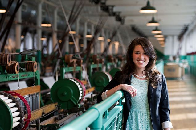 Chelsea Bray poses for a portrait with cotton milling machines in the historical Boott Cotton Mill in Lowell, MA said to be an inspiration for A Christmas Carol by Charles Dickens