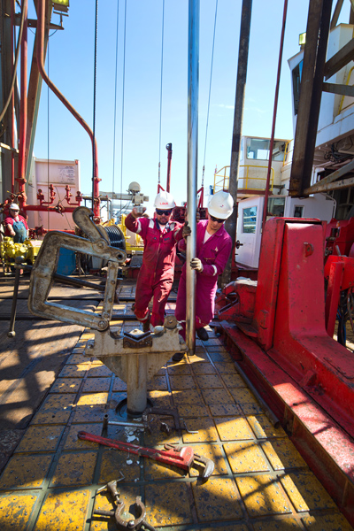 To extract core samples, the drill team lowers core barrels to the ocean floor where a drill burrows them into the Earth's crust. Photo by William Crawford, IODP/TAMU