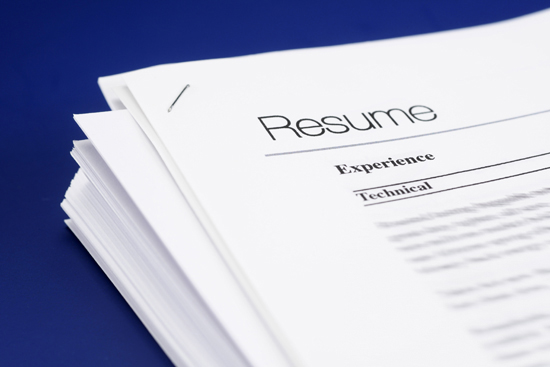 A stack of generic resumes sitting on a desk