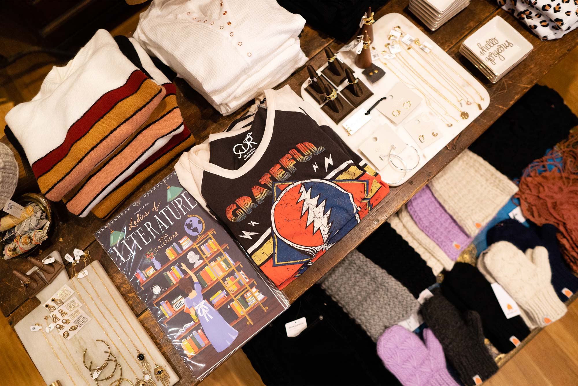 Products, including jewelry and shirts, are displayed on a table in the store Flock located in Boston's South End neighborhood.