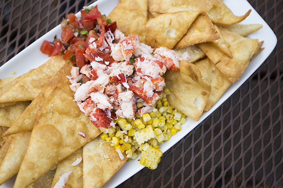 The lobster guacamole comes piled high with fresh lobster, pico de gallo, and roasted corn. 