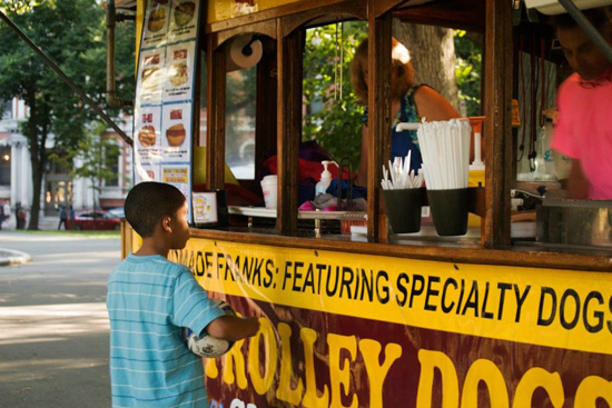 Boy ordering from Trolley Dogs food truck