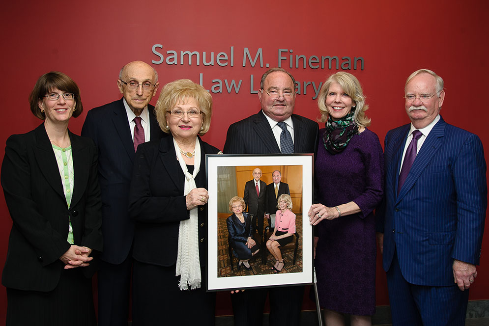 Samuel Fineman dedicated the new law library in honor former BU Law Dean William Schwartz and his wife Bernice Schwartz. They are holding a photo of Bernice Schwartz, William Schwartz, Samuel Fineman, and Nyla Carleton that will hang in the new library.