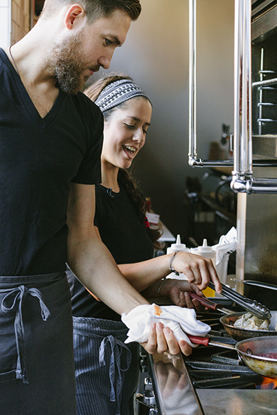 Chef-owners Jakob White (MET’09) and Fernanda Tapia-White (MET’09), graduates of the MET Certificate Program in the Culinary Arts, in the kitchen of their Newton restaurant, Comedor.