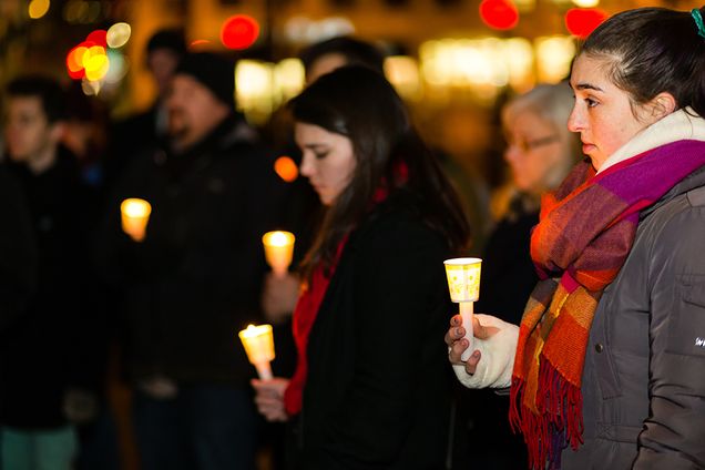 Boston University Against Gun Violence invited members of the BU community to gather on Marsh Plaza for the third annual Vigil for Victims of Gun Violence, one of many happening across the country in solidarity with the Newtown Foundation. Event organizer Lindsay Fuori listens as another speaker provides the closing remarks. Photo by Dana J. Quigley