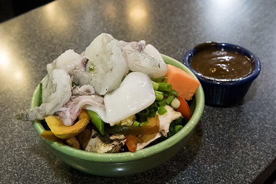 Diners can choose from a wide variety of meats, fish, vegetables, sauces, and more cooked on what the place claims is the world's largest Mongolian grill. 