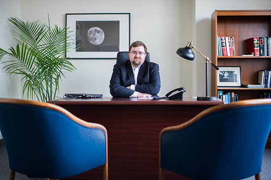 Michael Denham, a recent law graduate poses for a photo at his Kenmore Square office on Thursday, February 11, 2015. BU, BC and NU are partnering on an operation that sets up recent law grads to handle cases for people who have hard time affording lawyers - non-criminal cases like landlord/tenant and workplace issues.